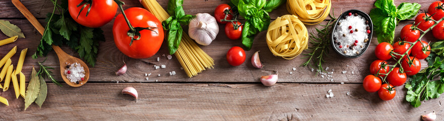 Wall Mural - Uncooked pasta, vegetables, cooking food background