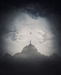© psychoshadow - Spooky scene with a lone boy holding a red balloon on top of a mountain facing a mysterious creature with giant scary hands coming out of the fog. Fantasy adventure and thrill background