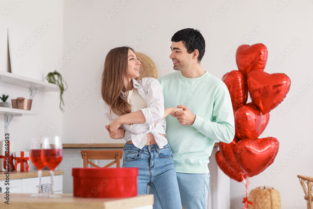 Young couple dancing in kitchen on Valentine's Day