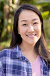 © Wavebreak Media - Portrait of happy asian woman looking at camera and smiling in garden