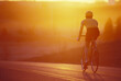 © Cavan Images - Road cyclists riding at sunset.