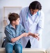 © Elnur - Hand injured boy visiting young male doctor