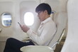 © sittinan - Traveling and Business concept,man sitting near windows on airplane during flight