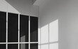 Sunlight and shadow on surface of black tinted glass with white cement wall of office building in monochrome style