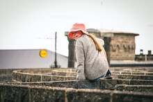 Girl Sitting On Maze Wall At Kryal Castle In Ballarat, Victoria Australia