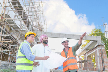 Wall Mural - Diverse team of professionals using tablet computers on construction site. Real estate construction project. with civil engineers, architects, Arabic business investors and explorer with theodolite