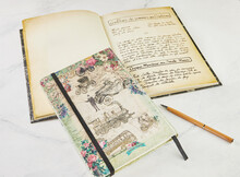 Old Book With Recipes In French And Notebook For Writing With Pen On White Marble