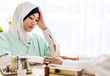 © Art_Photo - Muslim asian woman doctor service help support discussing and consulting talk to muslim woman patient at meeting health medical care express trust concept in hospital.healthcare and medicine