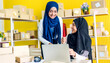 © Art_Photo - Muslim two asian woman freelancer sme business online shopping working and checklist order with cardboard box on table at home - Business online shipping and delivery concept