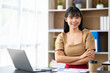 © crizzystudio - Portrait of successful confident pretty, young Asian businesswoman or freelancer standing near work desk in office, wearing formal stylish clothes, arms crossed, looking at camera, smiling friendly