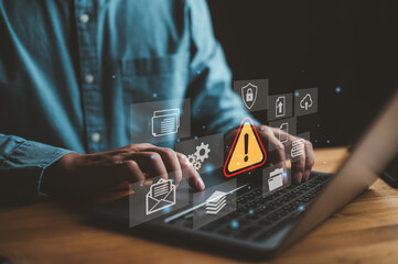 Businessman or it staff , programmer, developer using computer laptop with triangle caution warning sign for notification error and maintenance concept..