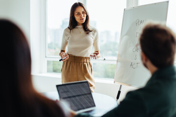 Poster - Female professional giving a presentation in an office
