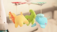 Baby Crib Mobile With Three Small Animals Yellow Lion, Green Crocodile, Blue Dolphin And Music. Spinning Children Toy Hold On Bed For Infant Newborn Baby. Side View