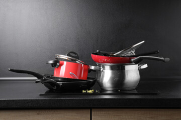 Canvas Print - Stacks of dirty kitchenware on cooktop in kitchen