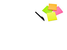 Black Pen And Sticky Note Sheets In Dayglo Colours On A Plain White Background. Copy Space.