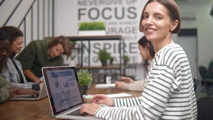 Wall Mural - young business woman using a laptop in a coworking center. Slow motion 60fps 4k.