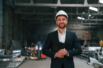 Wall Mural - Manager in black formal wear at the factory