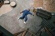 © standret - Top view of dead factory worker that lying on the ground. Conception of safety, bad accident
