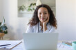 © Graphicroyalty - Youn Asian doctor using laptop and sitting at desk. Woman professional medic physician wearing white coat and stethoscope working on computer at workplace.