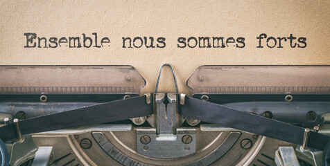 Wall Mural - Text written with a vintage typewriter - Together we are strong in french - Ensemble nous sommes forts