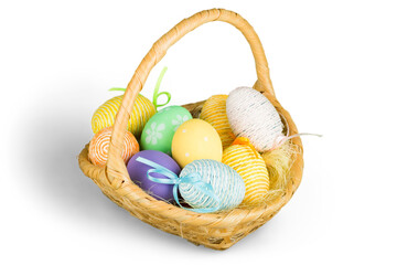 Wall Mural - Basket with colorful eggs isolated on white background