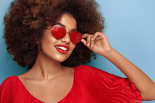 Beautiful Portrait Of An African Girl In Sunglasses In The Shape Of Hearts. Valentine's Day. Symbol Of Love