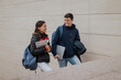 © ADDICTIVE STOCK - Cheerful students climbing up stairs together
