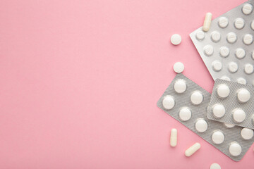 Wall Mural - Blister packs with medicines on pink background