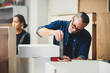 © DJ Creative Studio - Senior caucasian man specialist worker measuring white shelf furniture in wood workshop, Small business in wood furniture industry.