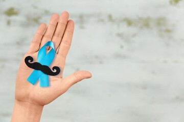 Sticker - Prostate Cancer concept, hand holding Blue Ribbon