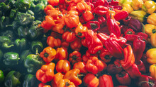 Full Frame Close-up Of Red, Orange, Yellow And Green Bell Peppers At A Market