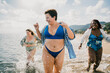 © oneinchpunch - Group of beautiful plus size women with swimwear bonding and having fun at the beach - Group of curvy female friends enjoying summertime at the sea, concepts about body acceptance, body positive