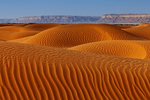 Desert Landscape With Ripped Sand Dunes With Mountain Backdrop, Saudi Arabia