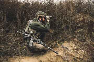 Wall Mural - Soldier with binocular investigating the place