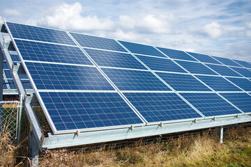 Solar power panel on blue sky background, alternative clean green energy concepts.