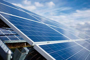 Solar power panel on blue sky background, alternative clean green energy concepts.