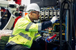 © 1st footage - Technician engineer holding robot controller checking and repairing automatic robotic machine at industrial factory, Worker working with robotic arm system in factory