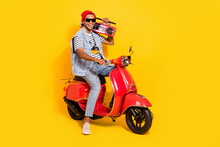 Full Length Photo Of Sweet Cool Guy Dressed Denim Clothes Driving Bike Enjoying Boom Box Isolated Yellow Color Background