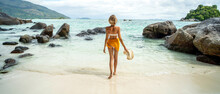 Full Length Photo Of A Beautiful Woman Enjoying Amazing View At The Tropical Beach. Summer Vacation Concept. Traveler.