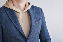 Detail Of Men Outfit, Blue Tweed Blazer Combined With Light Beige Hoodie. Selective Focus.
