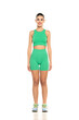 © vladimirfloyd - young sporty smiling woman in green shorts and top posing on white background