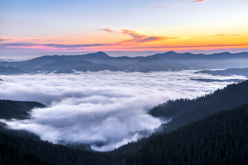 Wall Mural - Panorama with sunrise. Landscape with high mountains. Morning fog. Natural scenery.