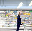 © lado2016 - Woman choosing frozen food from a supermarket freezer