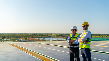 Wall Mural - portrait of professional man engineer maintaining solar cell panels together on factory building roo