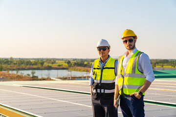 Wall Mural - portrait of professional man engineer maintaining solar cell panels together on factory building roo