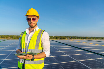 Wall Mural - portrait of professional man engineer maintaining solar cell panels on building rooftop. technician 