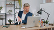 © Andrii Iemelianenko - Conflict, quarrel, negotiation. Angry mature businessman ceo making webcam laptop online video call at home office desk. Upset mad freelancer gray-haired old man talking colleague conversation indoors