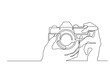 continuous line drawing hands holding photo camera - PNG image with transparent background