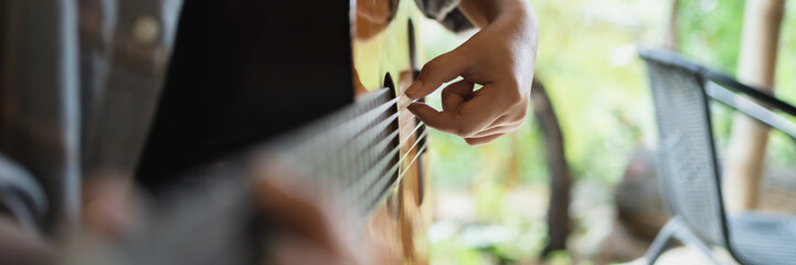 Happy young Woman hands playing acoustic guitar musician  alone compose instrumental song lesson on playing the guitar