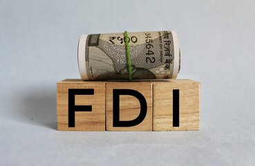 Concept of FDI or Foreign Direct Investment on wooden blocks.